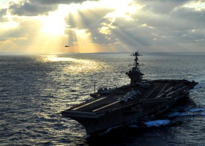 US Navy 091118-N-2013O-467 USS George Washington (CVN 73) transits the Pacific Ocean while an SH-60B Sea Hawk conducts flight operations in the background
