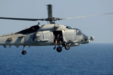 US Navy 091117-N-9500T-165 Naval Aircrewman 2nd Class Bryan Vesce prepares to jump from an SH-60B Sea Hawk helicopter to rescue three men