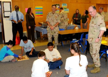 US Navy 091125-N-0803S-073 Adm. J. C. Harvey Jr., commander, U.S. Fleet Forces Command, speaks with students during a visit to the Department of Defense Dependent School in Bahrain