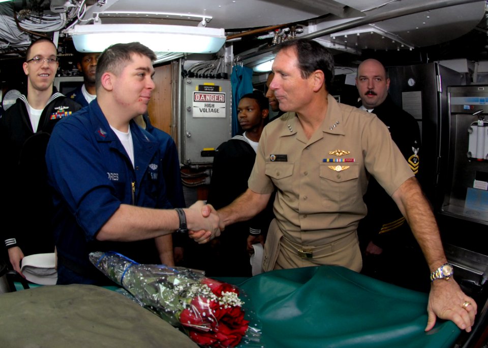 US Navy 091125-N-7705S-093 Vice Adm. Jay Donnelly, commander, Submarine Force, congratulates Electronics Technician 2nd Class Robert Flores for exceptional performance