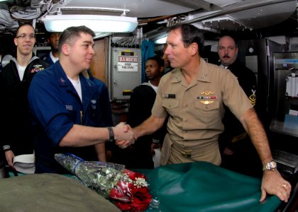 US Navy 091125-N-7705S-093 Vice Adm. Jay Donnelly, commander, Submarine Force, congratulates Electronics Technician 2nd Class Robert Flores for exceptional performance