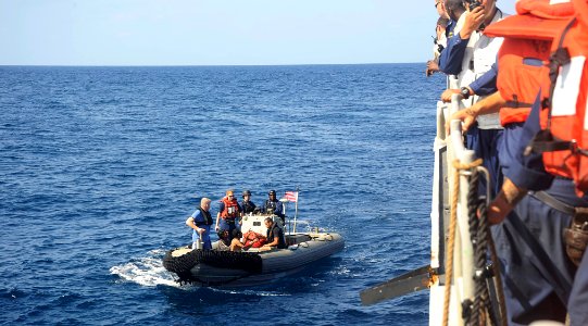US Navy 091117-N-9500T-564 Three men that were spotted clinging to a piece of wood in the Gulf of Aden are brought aboard USS Chosin (CG 65)