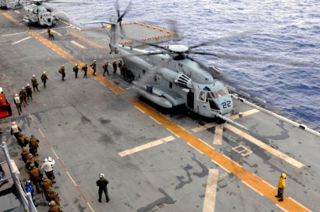 US Navy 091123-N-0890S-029 Marines board a CH-53E Super Stallion helicopter photo