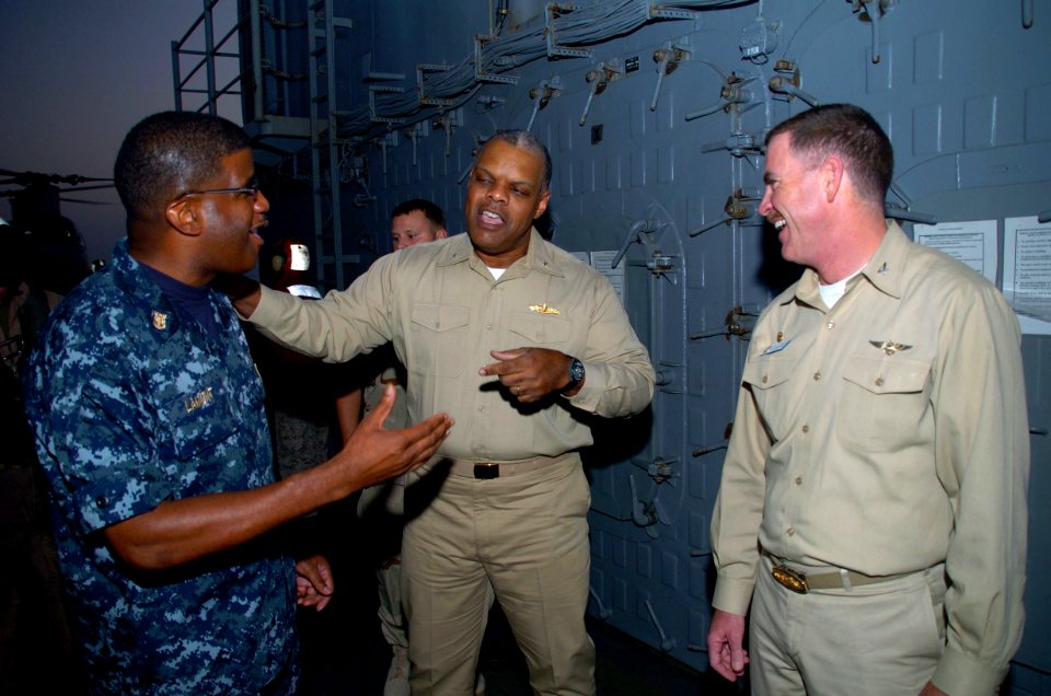 US Navy 091118-N-3925A-002 Rear Adm. Sinclair Harris speaks with Capt. Kevin Couch nd Command Master Chief Hassan Lamont