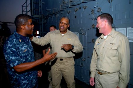 US Navy 091118-N-3925A-002 Rear Adm. Sinclair Harris speaks with Capt. Kevin Couch nd Command Master Chief Hassan Lamont