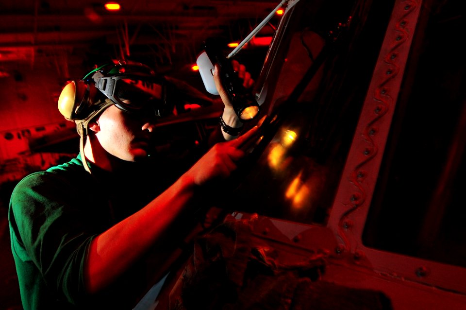 US Navy 091119-N-4053P-012 Aviation Structural Mechanic 3rd Class Jonathan Dowdy, assigned to the Indians of Anti-Submarine Squadron (HS) 6, performs corrosion treatment on the windshield wipers of an SH-60F Sea Hawk