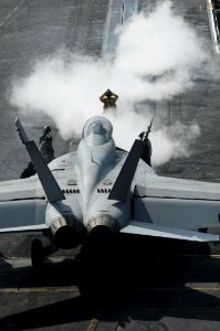 US Navy 091122-N-3038W-005 A flight deck director signals an F-A-18F Super Hornet onto catapult one aboard the USS Nimitz (CVN 68)