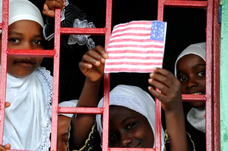 US Navy 091123-N-2420K-003 A student holds a drawing of an American Flag out of a classroom window during a dedication ceremony at the Nioumamilima Primary School in Nioumamilima