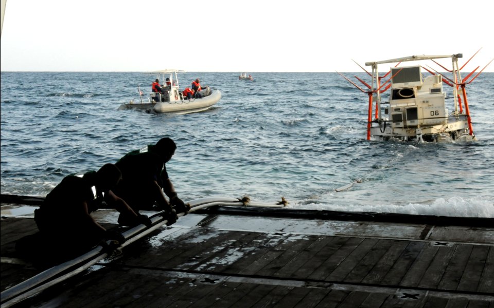 US Navy 091121-N-1291E-251 Sailors from Helicopter Mine Countermeasures Squadron (HM) 15 help pull in a MK-105 Mod 4 Sled, used for mine countermeasures