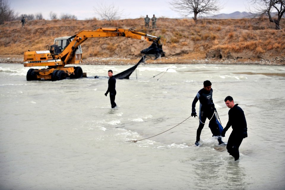 US Navy 091129-N-4154B-021 embers of Mobile Diving and Salvage Unit (MDSU) 2 attempt to pull an airdrop pallet from the waters of Bala Murgahab River