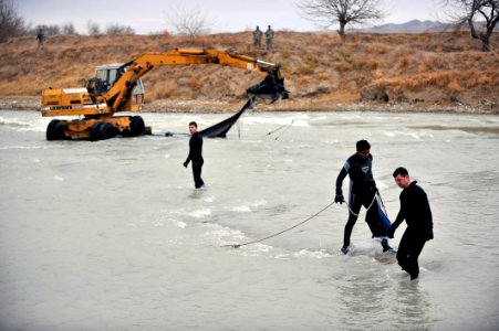 US Navy 091129-N-4154B-021 embers of Mobile Diving and Salvage Unit (MDSU) 2 attempt to pull an airdrop pallet from the waters of Bala Murgahab River