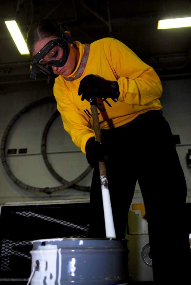 US Navy 091203-N-2475A-002 Aviation Boatswain's Mate (Handling) Airman Courteney Smith mixes paint