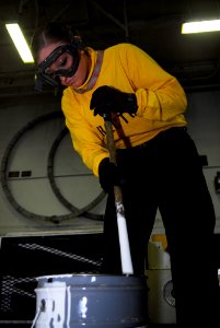 US Navy 091203-N-2475A-002 Aviation Boatswain's Mate (Handling) Airman Courteney Smith mixes paint