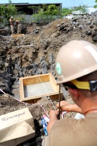 US Navy 091120-N-2420K-189 Constructionman Benjamin Kistner, assigned to Naval Mobile Construction Battalion (NMCB) 3, uses a string line to square a foundation