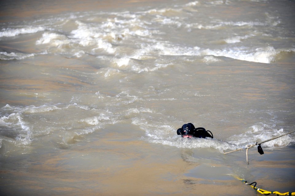 US Navy 091127-N-4154B-135 Navy Diver 1st Class Daniel Muhlbach, assigned to Mobile Diving and Salvage Unit (MDSU) 2, comes out of the water during a search for the body of U.S. Army Sgt. Brandon Islip