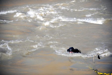 US Navy 091127-N-4154B-135 Navy Diver 1st Class Daniel Muhlbach, assigned to Mobile Diving and Salvage Unit (MDSU) 2, comes out of the water during a search for the body of U.S. Army Sgt. Brandon Islip