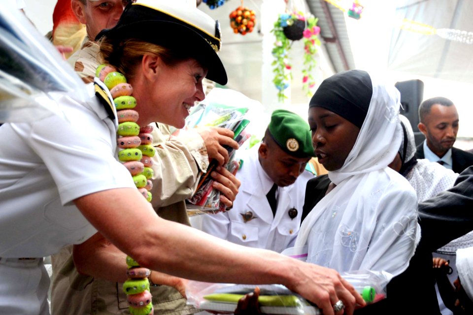 US Navy 091123-N-2420K-520 Capt. Alyson Caddell, strategic communication director for Combined Joint Task Force-Horn of Africa presents school supplies to a student at the Nioumamilima Primary School
