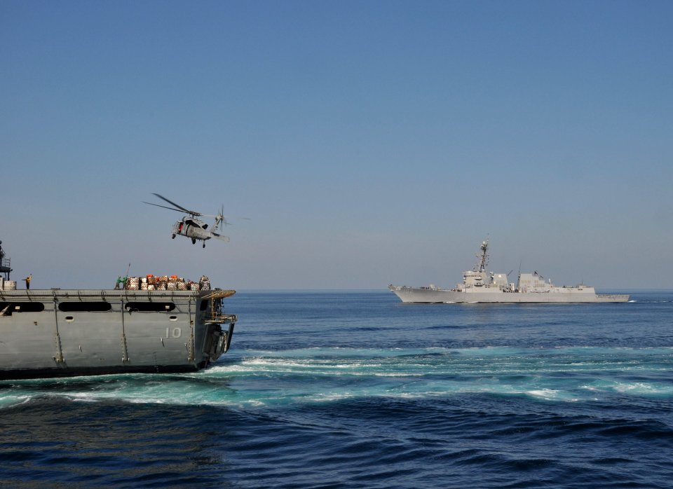 US Navy 091120-N-8421M-005 An MH-60S Sea Hawk helicopter transfers supplies from the Military Sealift Command fast combat support ship USNS Bridge (T-AOE-10) to the guided-missile destroyer USS Sampson (DDG 102)