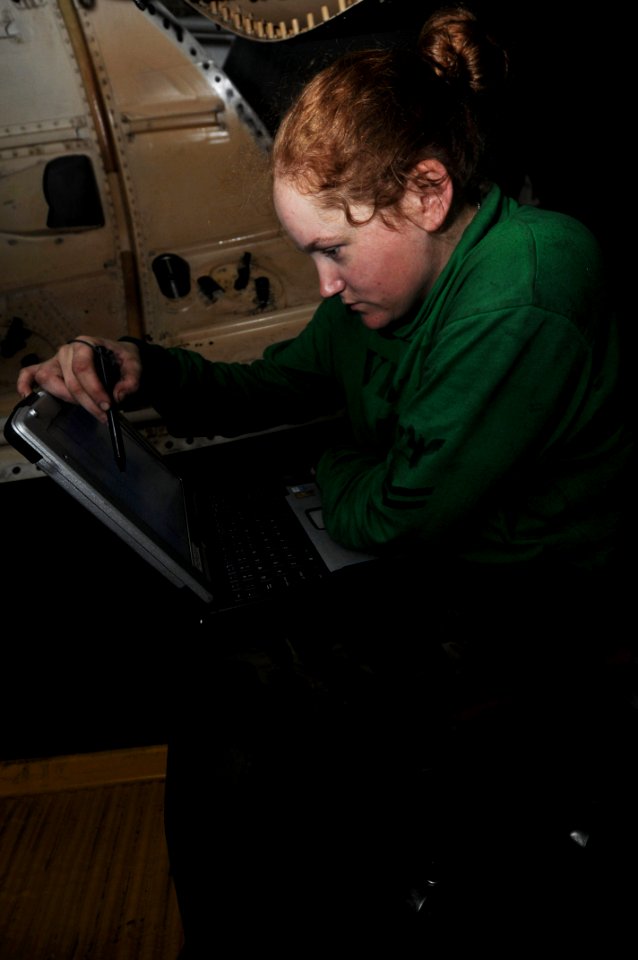 US Navy 091123-N-3038W-031 Aviation Machinist's Mate 2nd Class Jennifer Hanson inspects a computer schematic for an F-A-18F Super Hornet