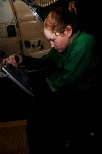US Navy 091123-N-3038W-031 Aviation Machinist's Mate 2nd Class Jennifer Hanson inspects a computer schematic for an F-A-18F Super Hornet
