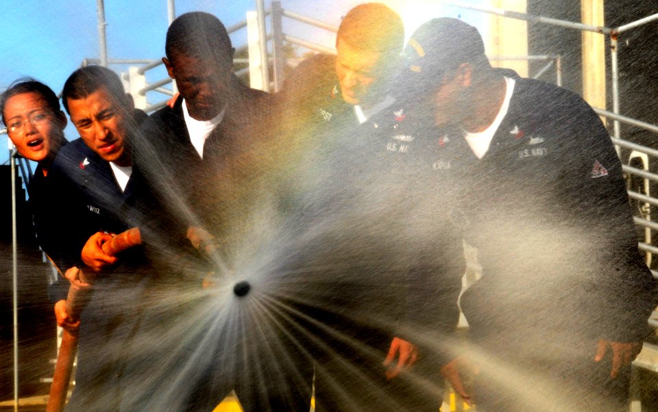 US Navy 091130-N-7498L-101 Sailors assigned to the Arleigh Burke-class guided-missile destroyer USS Chung-Hoon (DDG 93) cycle through the different hose settings during a Surface Line Week damage control Olympics
