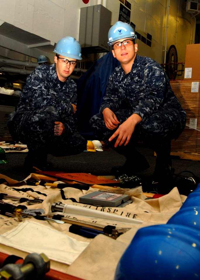 US Navy 091201-N-9116S-186 Seaman Scott A. Cloar nd Boatswain's Mate 3rd Class Rene Barriere prepare underway replenishment gear for inspection