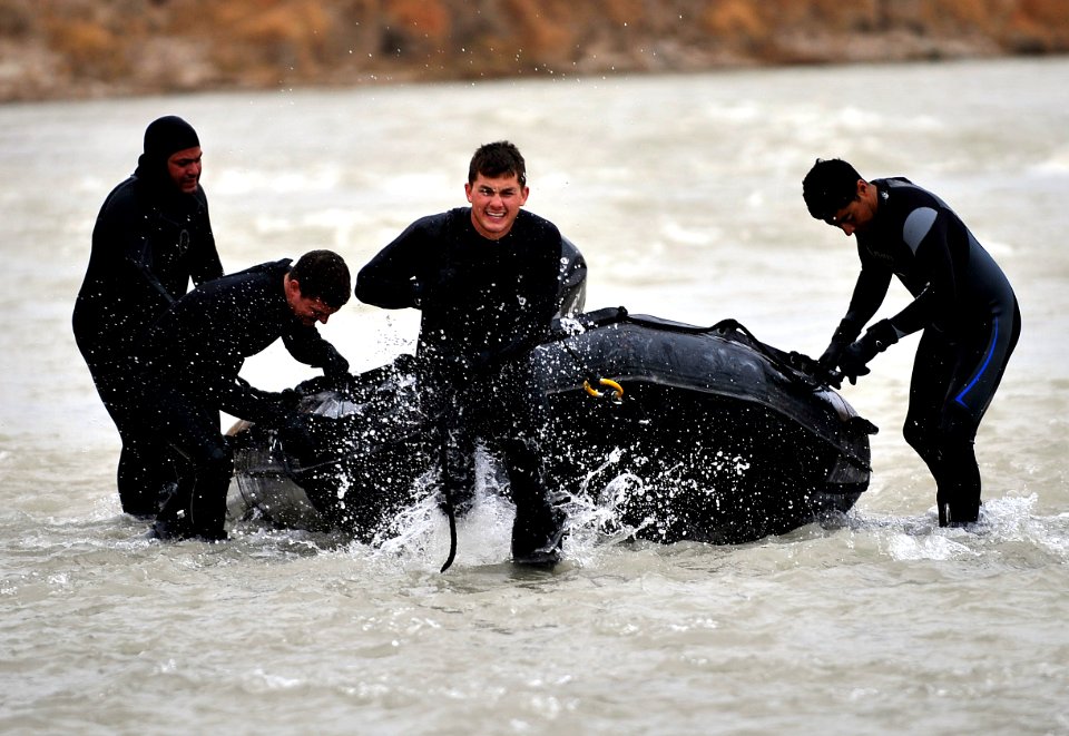 US Navy 091129-N-4154B-078 Sailors drag a Zodiac inflatable boat up Bala Murgahab River during a search for the body of U.S. Army Sgt. Brandon Islip