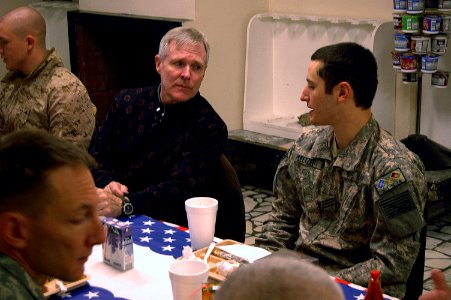 US Navy 091126-N-3218H-048 Secretary of the Navy (SECNAV) the Honorable Ray Mabus speaks with Seaman Joshua Seltzer, from Philadelphia, during a breakfast at Camp Eggers in Kabul, Afghanistan photo