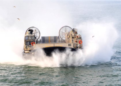 US Navy 091204-N-8655E-365 A landing craft air cushion (LCAC) from Assault Craft Unit (ACU) 4 returns to the well deck of multipurpose amphibious assault ship USS Bataan (LHD 5) photo