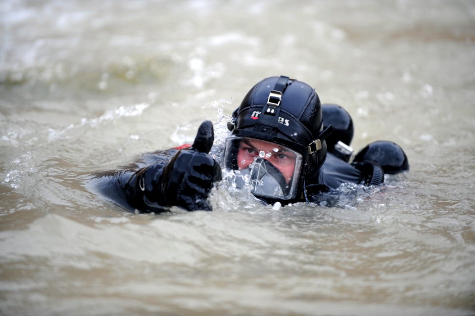 US Navy 091128-N-4154B-063 Navy Diver 2nd Class Zachery Dojaquez comes to the surface of the water during a dive