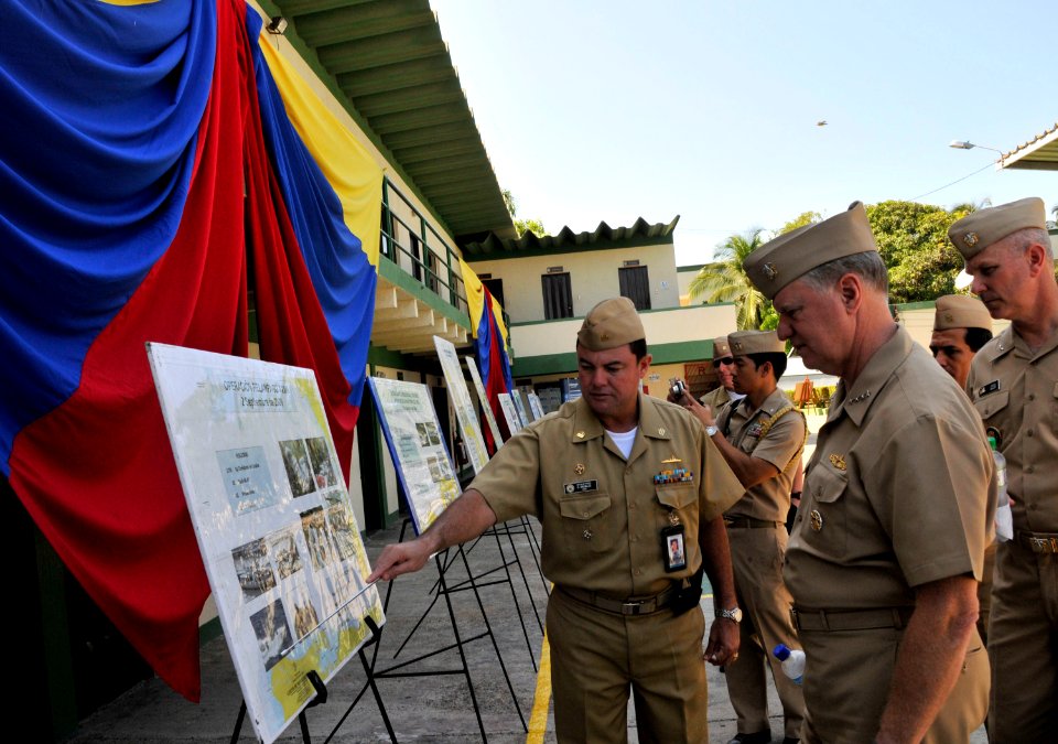 US Navy 091205-N-8273J-155 Cmdr. Orlando Grisales, assigned to Colombian Coast Guard Forces, Caribbean, left, shows Chief of Naval Operations (CNO) Adm. Gary Roughead information on recent operations in the Caribbean at Naval