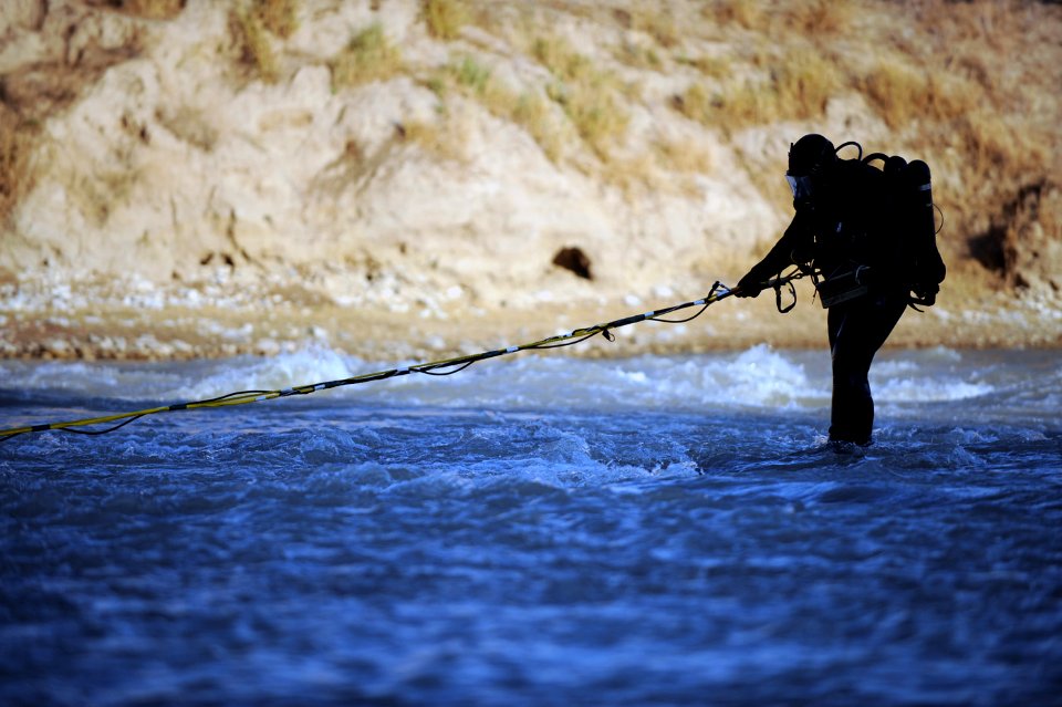 US Navy 091127-N-4154B-229 Explosive Ordnance Disposal Technician Edwin Sharpe, assigned to Mobile Diving and Salvage Unit (MDSU) 2, works his way through the Bala Murgahab River during a search for the body of U.S. Army Sgt. B