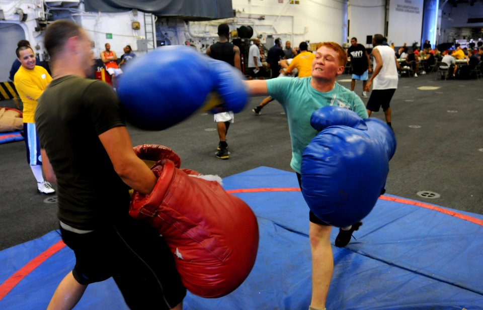 US Navy 091206-N-0890S-067 Sailors enjoy a boxing match in the hangar bay of the multi-purpose amphibious assault ship USS Wasp (LHD 1) during a steel beach picnic