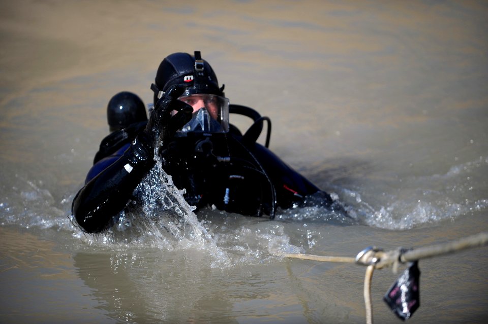 US Navy 091127-N-4154B-130 Navy Diver 1st Class Daniel Muhlbach, assigned to Mobile Diving and Salvage Unit (MDSU) 2, comes out of the water during a search for the body of U.S. Army Sgt. Brandon Islip