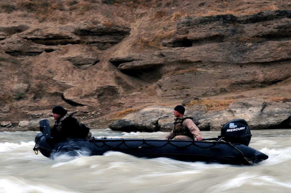 US Navy 091129-N-4154B-284 Sonar Technician (Surface) 1st Class Keith Boise attempts to steer from the bow of a Zodiac inflatable boat in Afghanistan