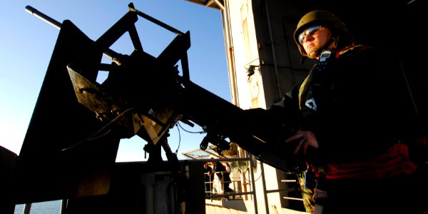 US Navy 091202-N-2475A-063 Aviation Ordnanceman Airman Lindsey Poole mans a .50-caliber machine gun photo