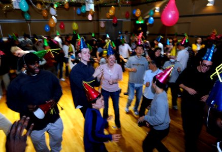 US Navy 091202-N-7280V-285 Sailors dance at the annual Christmas Disco Party for the disabled during a community outreach project