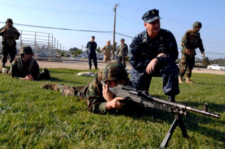 US Navy 091202-N-9818V-512 Master Chief Petty Officer of the Navy (MCPON) Rick West looks over Utilitiesman Michael McTaggart, assigned to Naval Mobile Construction Battalion (NMCB) 5, during a training evolution at Naval Base