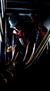 US Navy 091206-N-9928E-073 Seaman Brandon West, from Willis, Texas, stows a steady line, used to lower a rigid hull inflatable boat, on the starboard boat deck aboard the Nimitz-class aircraft carrier USS John C. Stennis (CVN 7