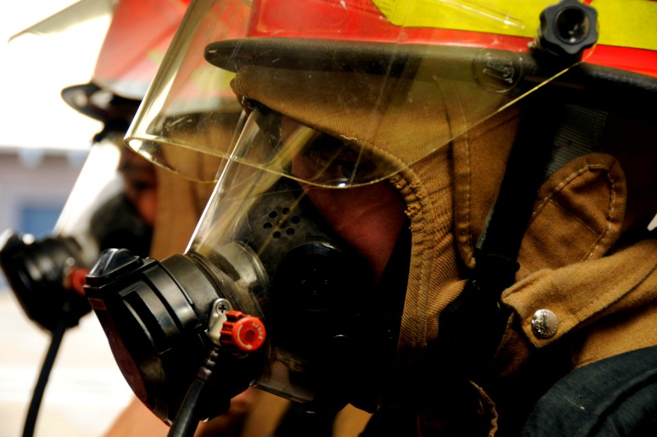 US Navy 091130-N-7498L-153 Sailors assigned to the Arleigh Burke-class guided-missile destroyer USS Russell (DDG 59) don fire fighting equipment as they participate in a Surface Line Week damage control Olympics
