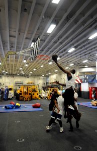 US Navy 091206-N-0890S-012 Sailors play basketball in the hangar bay of the multi-purpose amphibious assault ship USS Wasp (LHD 1) during a steel beach picnic