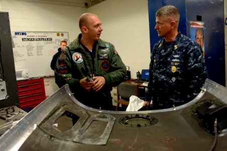 US Navy 091201-N-9818V-038 Master Chief Petty Officer of the Navy (MCPON) Rick West talks with Aviation Structural Mechanic 1st Class Michael McKown during a tour of the hangar spaces of Carrier Air Wing (CVW) 14