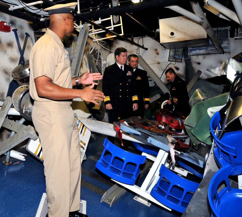 US Navy 091204-N-8848T-799 Chief Boatswain's Mate Donald Walker shows a bomb damaged berthing compartment on the Arleigh Burke-class destroyer simulator, USS Trayer (BST 21)