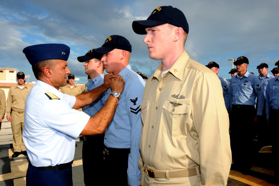US Navy 091204-N-1906L-003 Rear Adm. Manson Brown presents special operations ribbons to Chief Electronics Technician Calvin Williams, Boatswain's Mate 2nd Class Chris Nuemann, and Operations Specialist 3rd Class Seth Miller