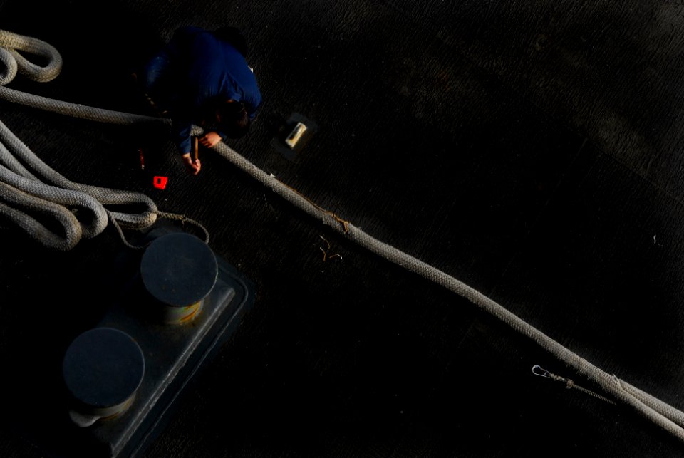 US Navy 091208-N-2475A-011 Seaman Madelin Acosta, from West Palm Beach, Fla., assigned to the aircraft carrier USS John C. Stennis (CVN 74) splices a tattle-tale into a mooring line