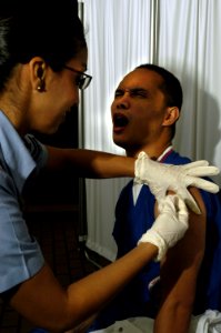 US Navy 091208-N-4378P-011 Hospital Corpsman 2nd Class Victoria A. Cruz administers the H1N1 flu vaccine to Hospital Corpsman 3rd Class Ronald Dizon at Naval Medical Center San Diego photo