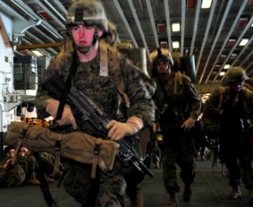 US Navy 091204-N-9740S-016 Marines assigned to the 22nd Marine Expeditionary Unit prepare to depart the amphibious assault ship USS Bataan (LHD 5) photo