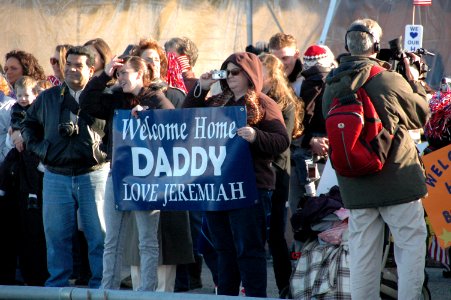 US Navy 091208-N-9806M-027 Families and friends of Sailors aboard the amphibious transport dock ship USS Ponce (LPD 15) wait for the ship to arrive at Naval Station Norfolk