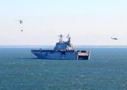 US Navy 091206-N-8655E-002 Two MH-60S Sea Hawk helicopters, assigned to Helicopter Sea Combat Squadron (HSC) 28, transfer ammunition from the multi-purpose amphibious assault ship USS Bataan (LHD 5) to the amphibious assault sh