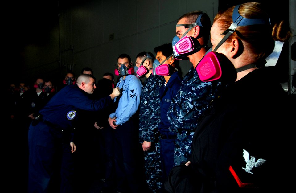 US Navy 091209-N-2475A-020 Logistics Specialist 2nd Class Dan Foster, from Hutchinson, Kan., performs respirator fit tests on Sailors in hangar bay one